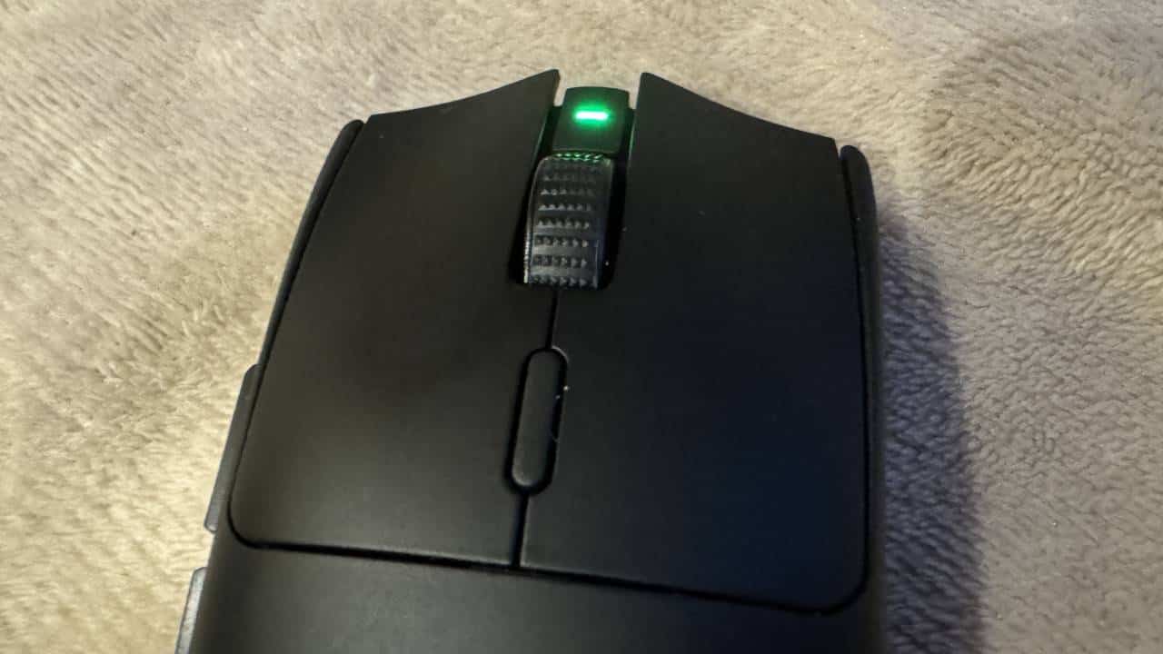 A sleek gaming mouse with a vibrant green light.