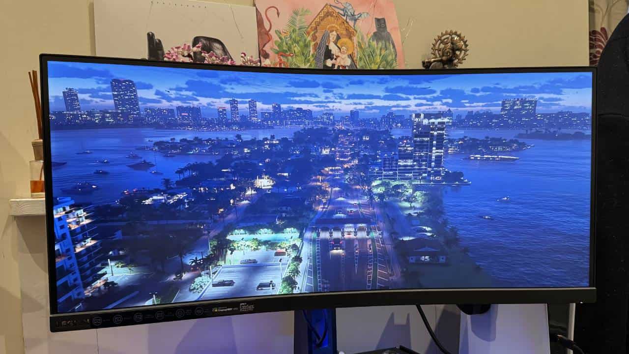 A curved tv with a city view on it, featuring the Lenovo Legion Y34wz-30.