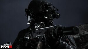 A soldier in the popular game MW3 is holding a gun on a dark background.