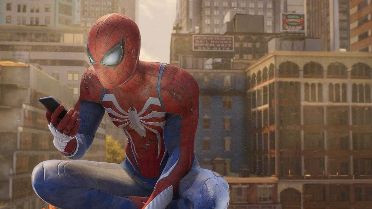 A Spider-Man is sitting on top of a building, occasionally glancing at his phone.