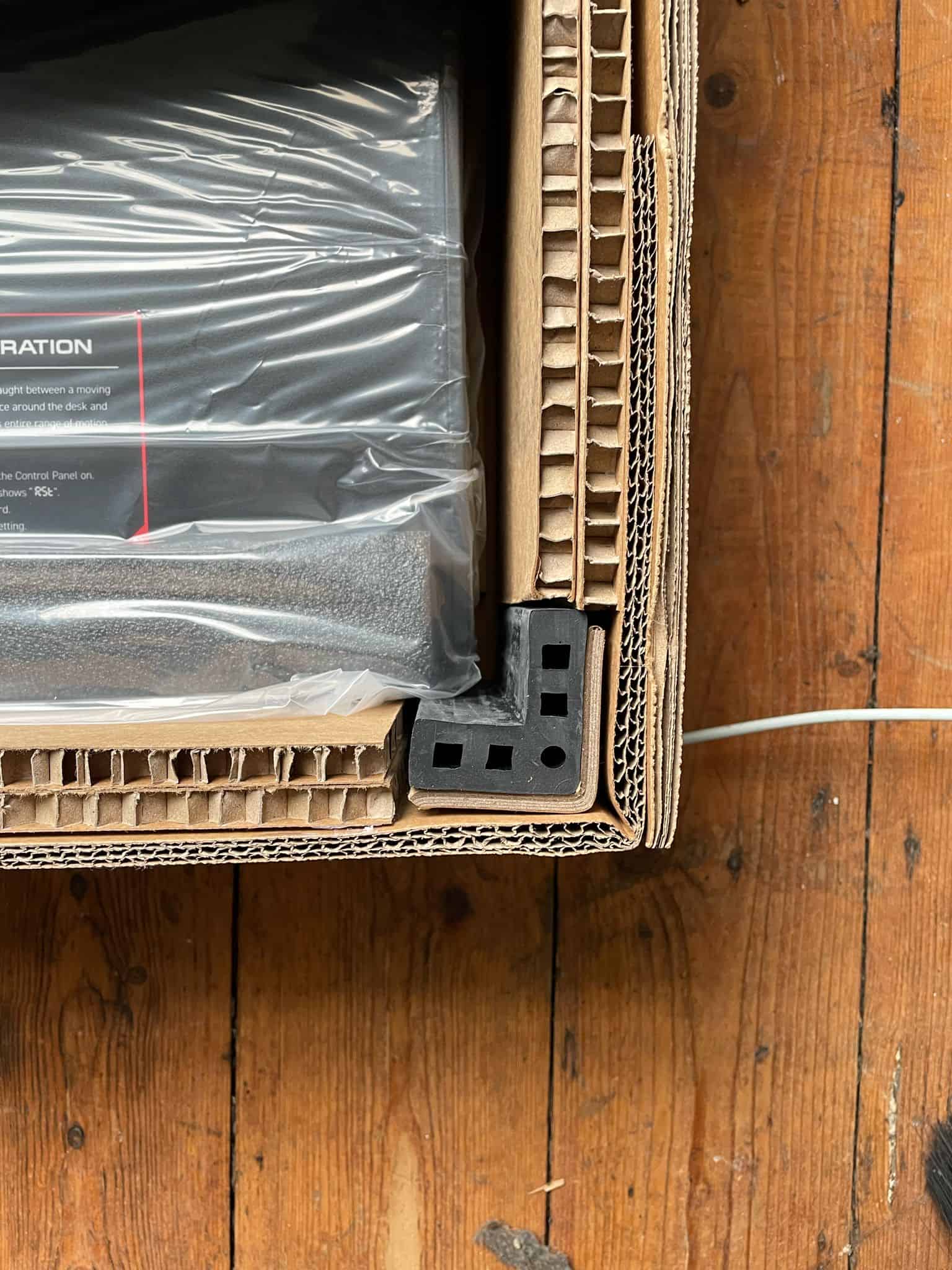 A laptop box placed on a wooden floor.
