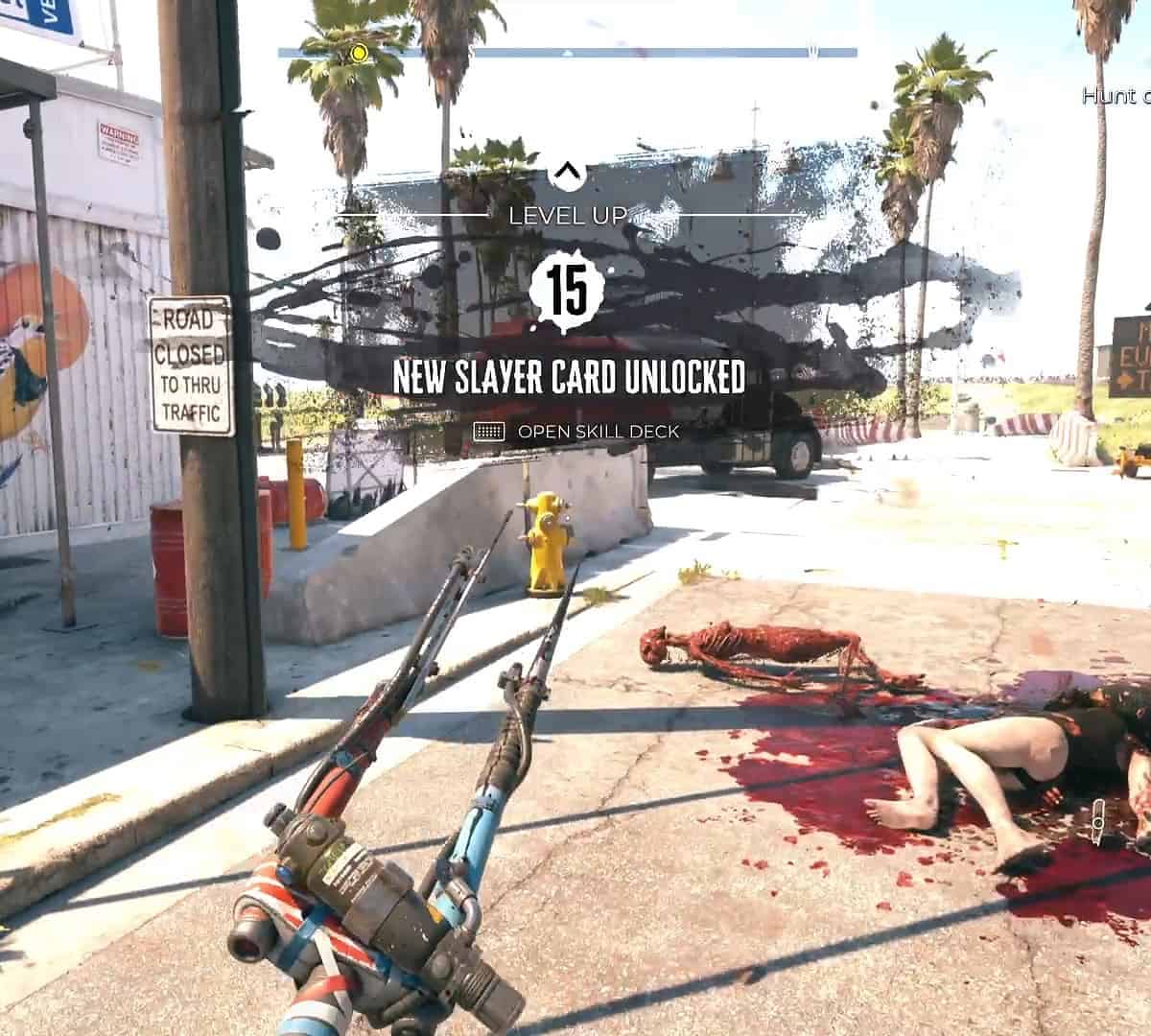 Dead Island 2 review: Holding an electrified pitchfork as the level up splash text is on screen for level 15 with a new slayer card unlocked.