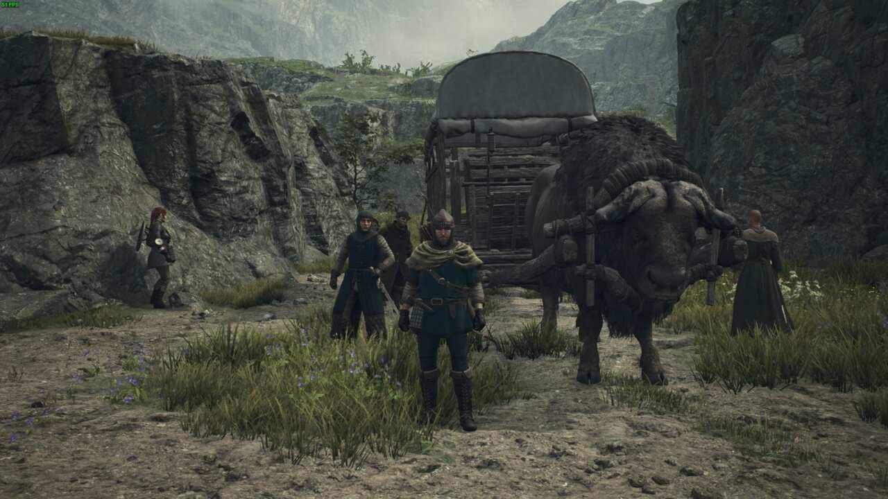 A group of characters in a medieval fantasy setting reminiscent of Dragon's Dogma 2, with a person guiding a large beast of burden carrying a carriage through rocky terrain to facilitate fast travel.
