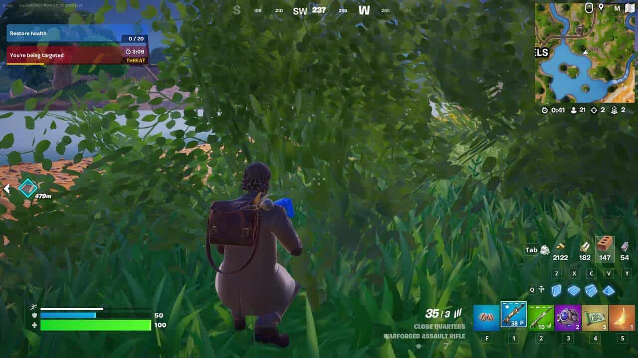 Fortnite best hiding spots: A player crouching in a bush in Fortnite.