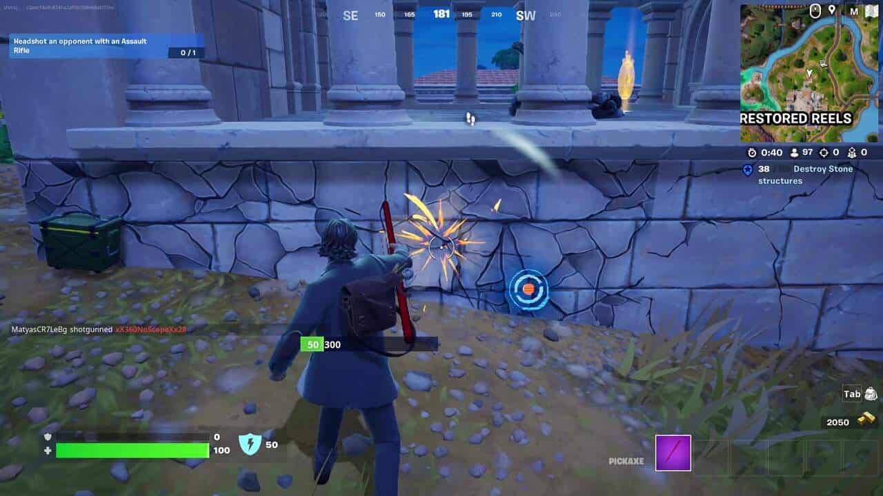 Fortnite best hiding spots: A player breaking a marble wall on a building in Fortnite.