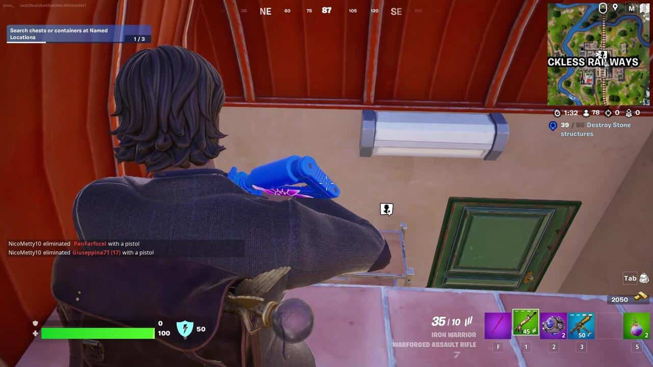 Fortnite best hiding spots: A player with a gun looking down below them at a door in Fortnite.