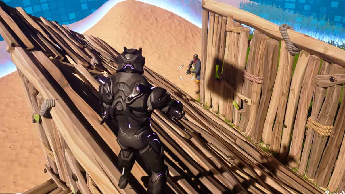 A man is standing on a wooden platform in Fortnite Creative.