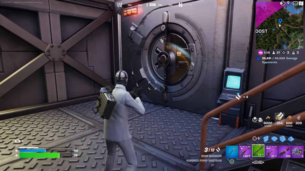 A player in a silver outfit is standing near a vault door inside a structure in the game Fortnite Chapter 5 Season 2: All vault locations.