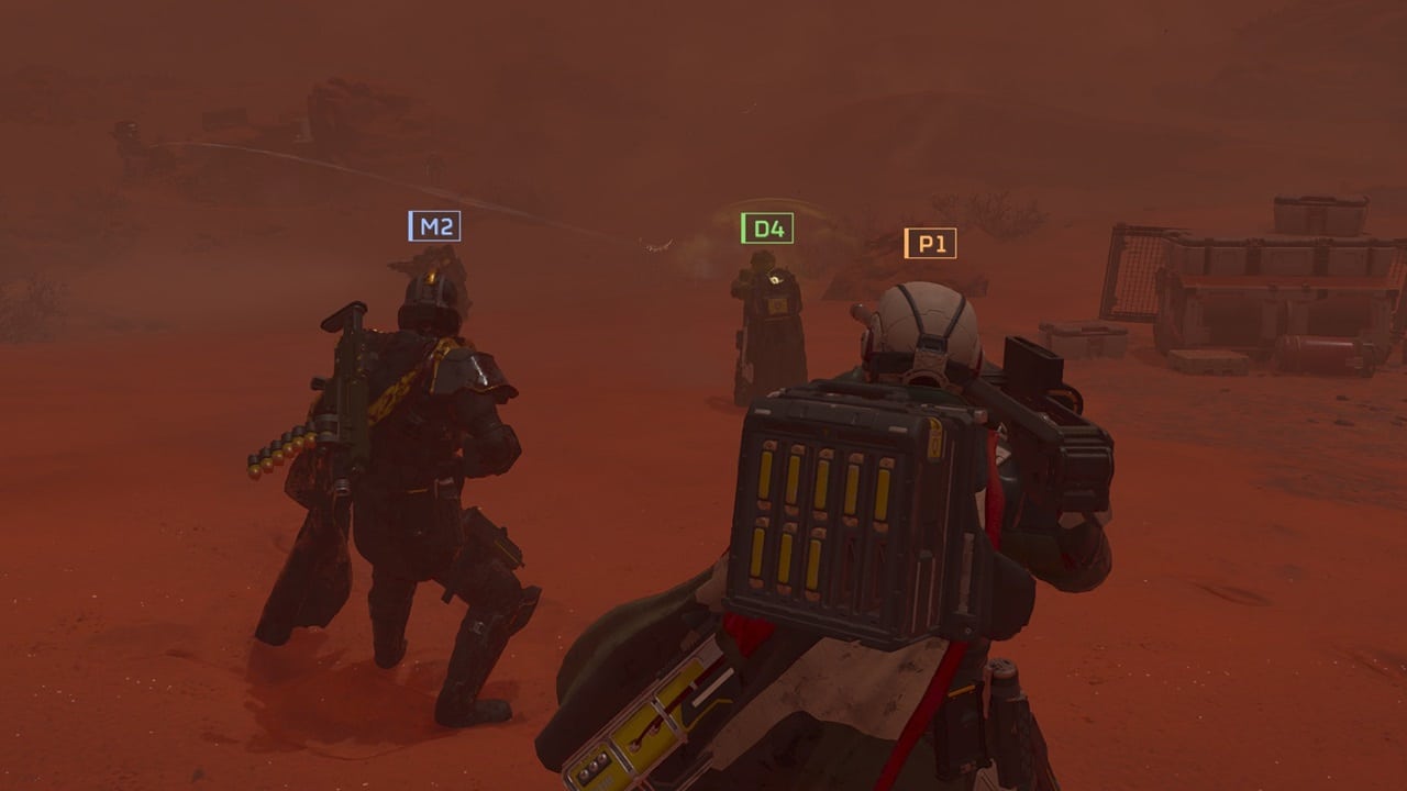 Helldivers 2 best loadouts: Three players standing in a dusty region in the game. Image captured by VideoGamer.