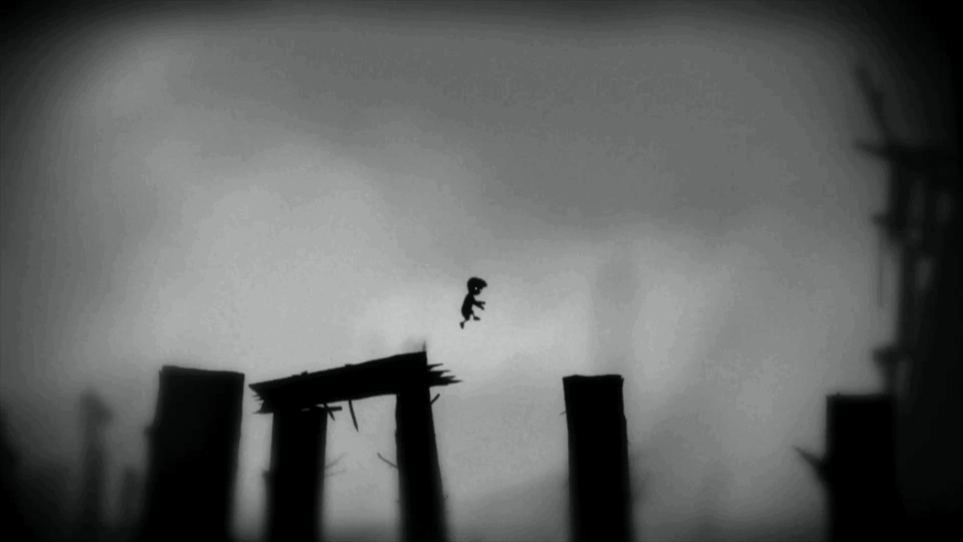 An image of a person on top of wooden poles in black and white.