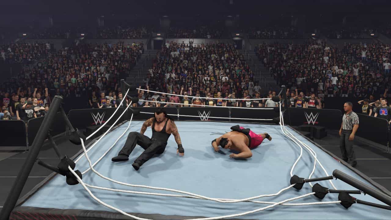 How to break the ring in WWE 2K24 - two wrestlers at the edge of the ring.